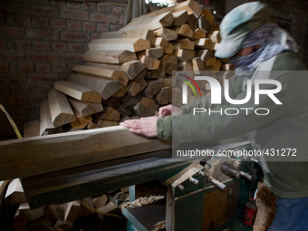 HALMULLAH, INDIAN ADMINISTERED KASHMIR, INDIA - FEBRUARY 11: A workers shape willow cleft used in making cricket bats in a cricket bat facto...