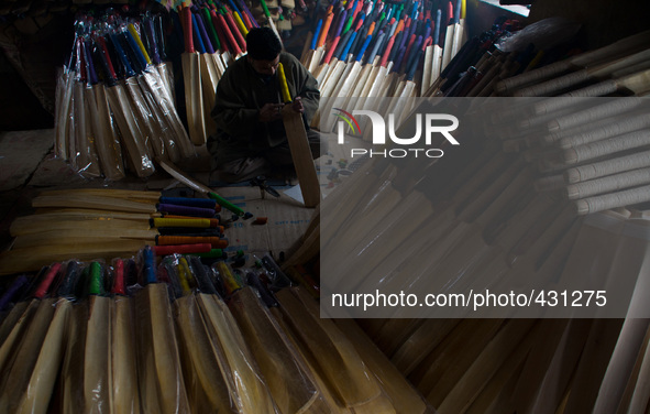 HALMULLAH, INDIAN ADMINISTERED KASHMIR, INDIA - FEBRUARY 11: A workers gives finishing touches to  cricket bat in a bat factory on February...