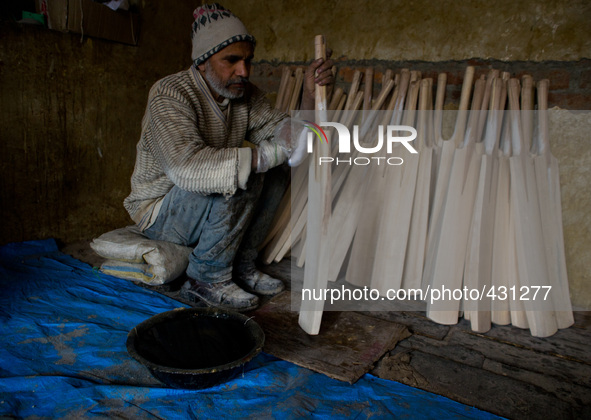 HALMULLAH, INDIAN ADMINISTERED KASHMIR, INDIA - FEBRUARY 11: A workers polishes cricket bat  in a bat factory on February 11, 2015 in Halmul...