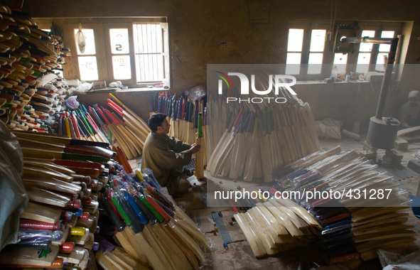 HALMULLAH, INDIAN ADMINISTERED KASHMIR, INDIA - FEBRUARY 11: Workers gives finishing touches to  cricket bat in a bat factory on February 11...