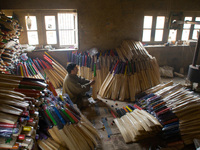 HALMULLAH, INDIAN ADMINISTERED KASHMIR, INDIA - FEBRUARY 11: Workers gives finishing touches to  cricket bat in a bat factory on February 11...