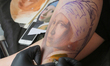 Master tattoos a man with Johannes Vermeer's "Girl with a Pearl Earring" during the tattoo...