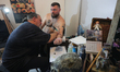 Master tattoos a man during the tattoo festival in Kyiv, Ukraine, May 17, 2019. 15th inter...