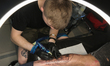 Master tattoos a man during the tattoo festival in Kyiv, Ukraine, May 17, 2019. 15th inter...