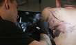Master tattoos a man's back during the tattoo festival in Kyiv, Ukraine, May 17, 2019. 15t...