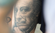 Salvador Dali portrait is seen tattooed on the leg during the tattoo festival in Kyiv, Ukr...