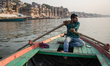 On 18 May 2018, a young Indian man rows a row boat on the Ganges River, which is considere...