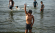 Palestinian children play in the Mediterranean sea on the beach in Gaza City during a heat...