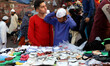 A Muslim boy tries a skull cap before purchasing it outside Jama Masjid in Old Delhi. 