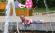 A kid plays at a fountain a sunny spring day in Kyiv, Ukraine, May 27,2019 