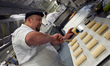 A baker finishes a chocolatine before cooking it. The first World Cup of Chocolatine (Fren...