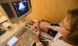Sonographer doing ultrasonography for ATO soldier in Military Hospital, Ukraine. During Uk...