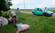 Pickers in the village of Tarnicheni bring their bags of roses to be weighed. Pickers rece...