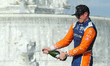 Scott Dixon (9) of New Zealand and Chip Ganassi Racing takes a champagne shower during the...