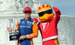 Scott Dixon (9) of New Zealand and Chip Ganassi Racing holds the winner’s trophy with Fire...