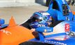 Scott Dixon (9) of New Zealand and Chip Ganassi Racing begins removing his helmet upon arr...