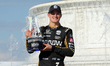 Marcus Ericsson holds his trophy during the post-race awards ceremony at the Winner’s Circ...