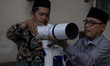 Indonesian observers installed a telescope to see the position of the moon to determine th...