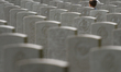A young boy walks between tombstones at the Bayeux War Cemetery, the largest Second World...