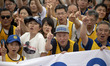 Participants pose for a photograph during the trash collection challenge event in Enoshima...