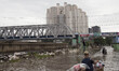 A seller walk on the flood on February 19, 2015 in Mangga Dua-Jakarta hit by flood again a...