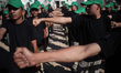 Young Palestinian boys take part in a military camp to teaching how to fire Kalashnikov as...