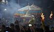 Nepalese Priests carrying idol Rato Machindranath towards Bungamati as devotees fire a tra...