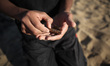 A Palestinian boy holds bullets of AK47 during a military training by Members of Al-Qassam...