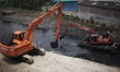 Bangladesh Pani Unnayan Board (BWDB) seen digging a canal besides Buriganga river in Dhaka...