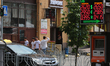 People walk past the currency exchange a sunny day at Khreshchatyk street in Kyiv, Ukraine...