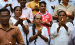 Sri Lankans hold candles during a candlelight vigil, as they pay tribute to the victims of...