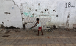 A boy plays a cricket at a parking lot in Mumbai, India on 23 June 2019. 