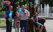 People take pictures sitting on iron Throne installed at Independence Square in Kyiv,  Ukr...