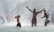 Parisians and tourists, adults and children alike, bathe in bathing suits or underwear in...