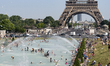 View from above of Parisians and tourists, adults and children alike, who bathe in bathing...