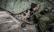 Cadet attaches the beam to the BMP-1 infantry fighting vehicle's track in case of stuck in...