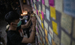 A Man is seen sticking notes to a wall in Hong Kong, China. 30 June 2019. 