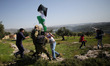 Israeli soldiers detain a Palestinian during clashes following a demonstration against Jew...