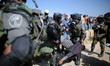 Israeli soldiers detain a Palestinian during clashes following a demonstration against Jew...