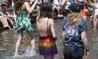 People play in Washington Square Park fountain at the annual Pride Parade on Sunday, June...
