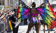 A parade goer wears rainbow butterfly wings and shorts at the annual Pride Parade on Sunda...