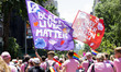 Black Lives Matter and Gay Liberation flags are waved at the annual Pride Parade on Sunday...