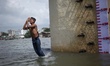Bangladeshi youth take a bath in the Buriganga river during a hot summer day in Dhaka, Ban...