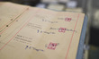 A Sotheby’s auction worker holds the original and first management contract between member...