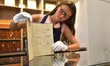 A Sotheby’s auction worker holds the original and first management contract between member...