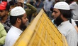 Two Muslim men talk near a Police Barricade in Chawri Bazaar in Old Delhi, India, on 7 Jul...