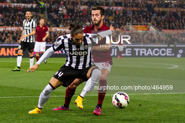 Juventus defender Martin Caceres (4) fights for the ball against Roma midfielder Miralem Pjanic (15) during the Serie A football match n.25...
