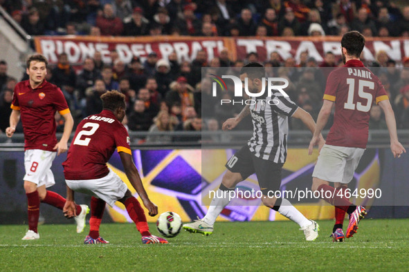 Juventus forward Carlos Tevez (10) fights for the ball against Roma defender Mapou Yanga-Mbiwa (2) and Roma midfielder Miralem Pjanic (15) d...