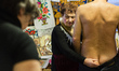 Milinchuk Halina, alternative medicine practitioner, heal her patient, rolling egg on his...