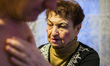 Milinchuk Halina, alternative medicine practitioner, heal her patient, rolling egg on his...